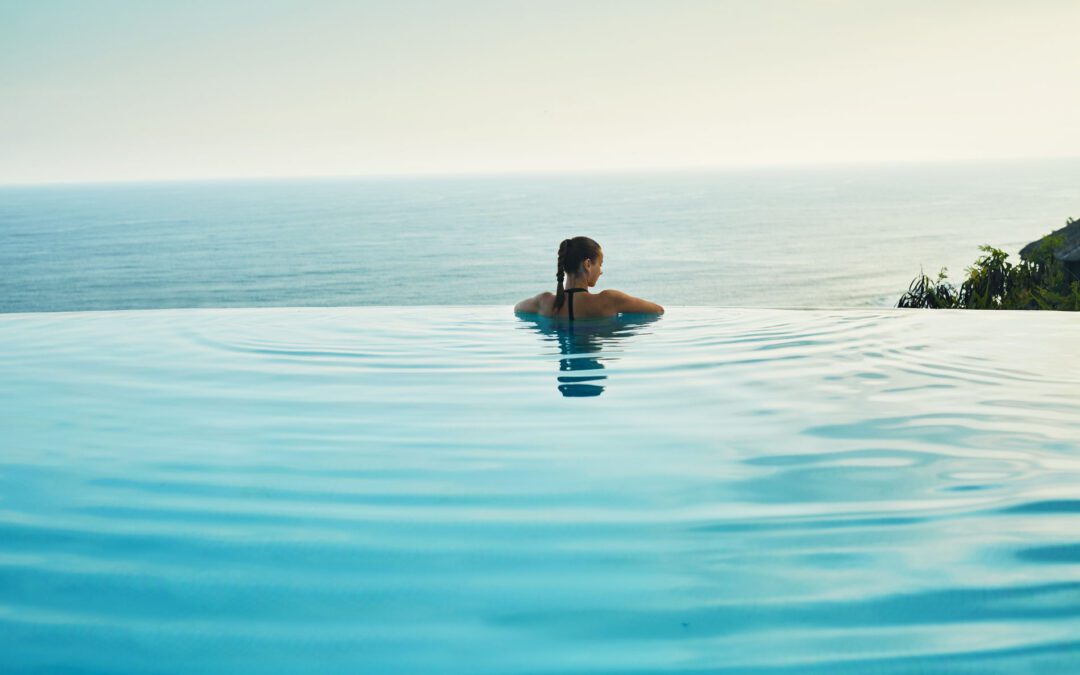 Luxury,Resort.,Woman,Relaxing,In,Infinity,Swimming,Pool,Water.,Beautiful